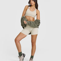 SoftMotionâ„¢ Sports Bra with White Logo | Sand