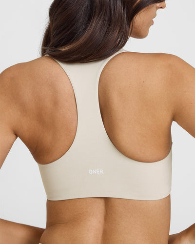SoftMotionâ„¢ Sports Bra with White Logo | Sand
