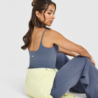 SoftMotionâ„¢ Strappy Mid Vest with Built in Bra Shelf with White Logo | Granite Blue