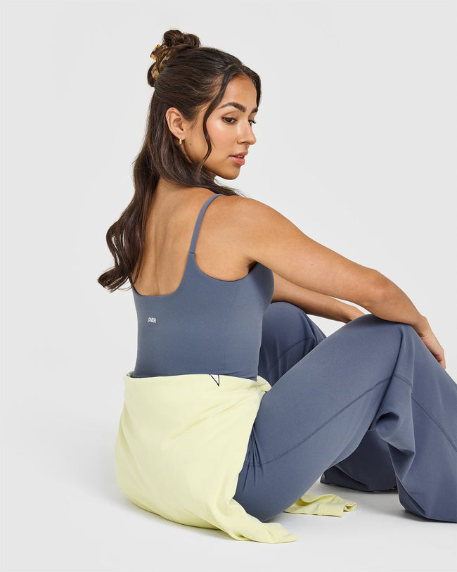 SoftMotionâ„¢ Strappy Mid Vest with Built in Bra Shelf with White Logo | Granite Blue