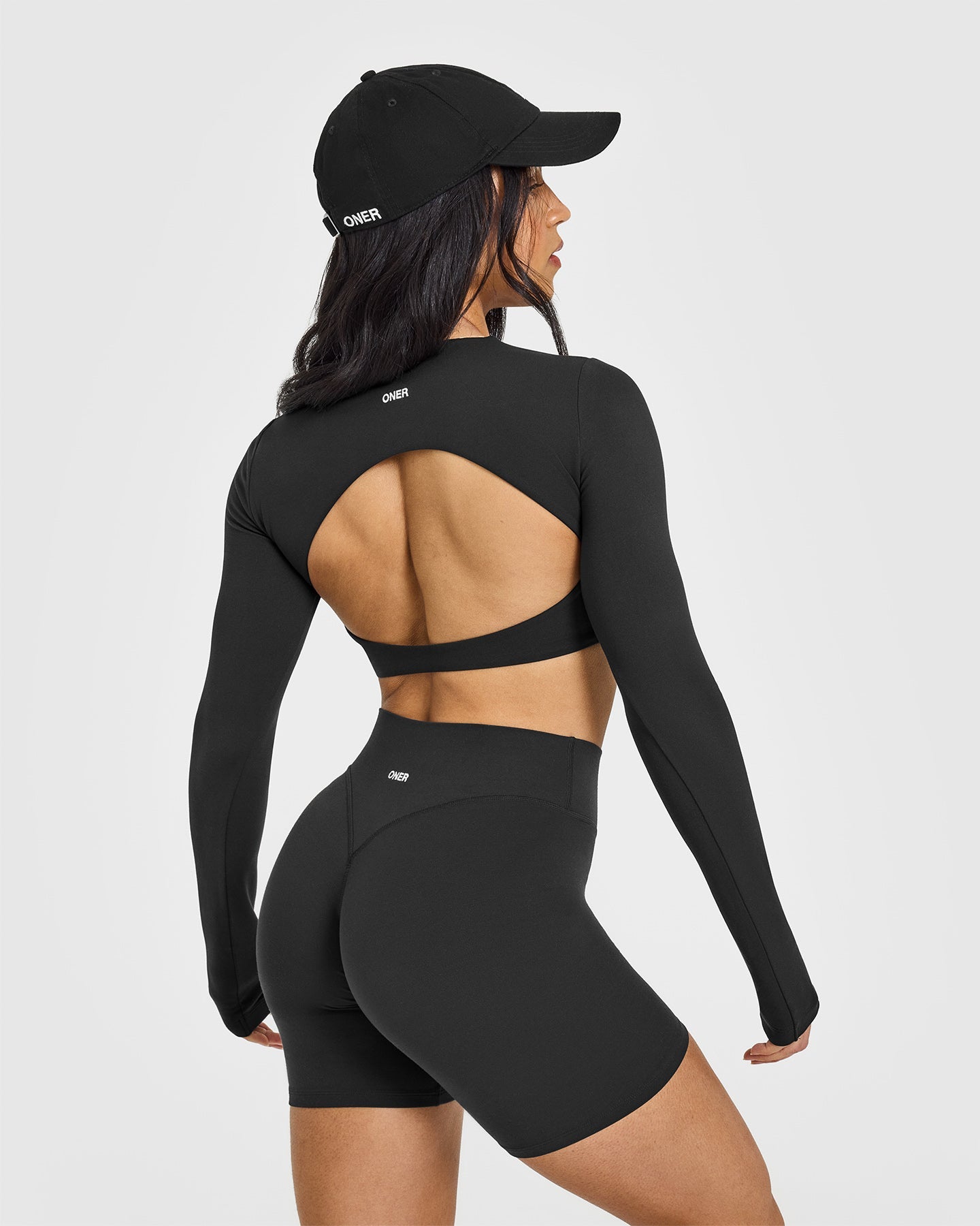 SoftMotionâ„¢ Long Sleeve Crop Top with White Logo | Soft Black