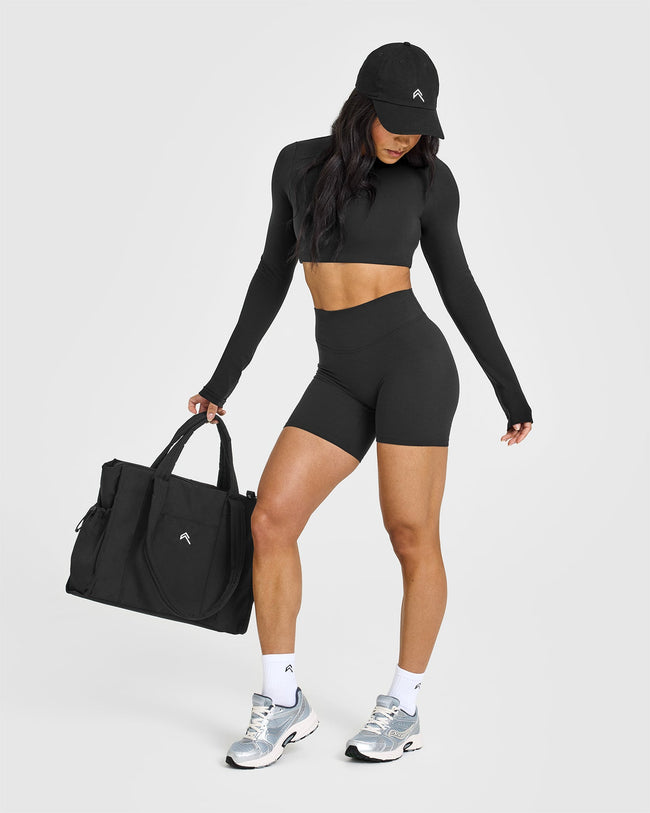 SoftMotionâ„¢ Long Sleeve Crop Top with White Logo | Soft Black