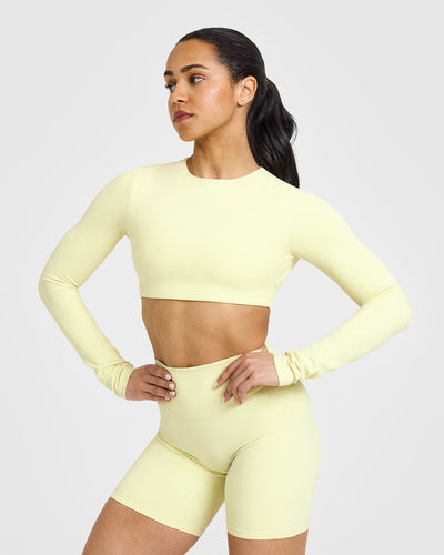 SoftMotionâ„¢ Long Sleeve Crop Top with White Logo | Pastel Yellow