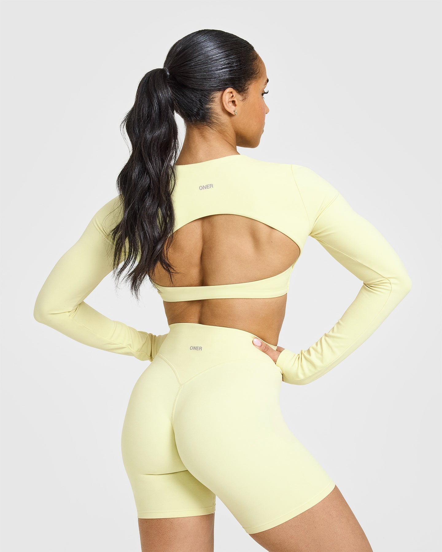 SoftMotionâ„¢ Long Sleeve Crop Top with White Logo | Pastel Yellow