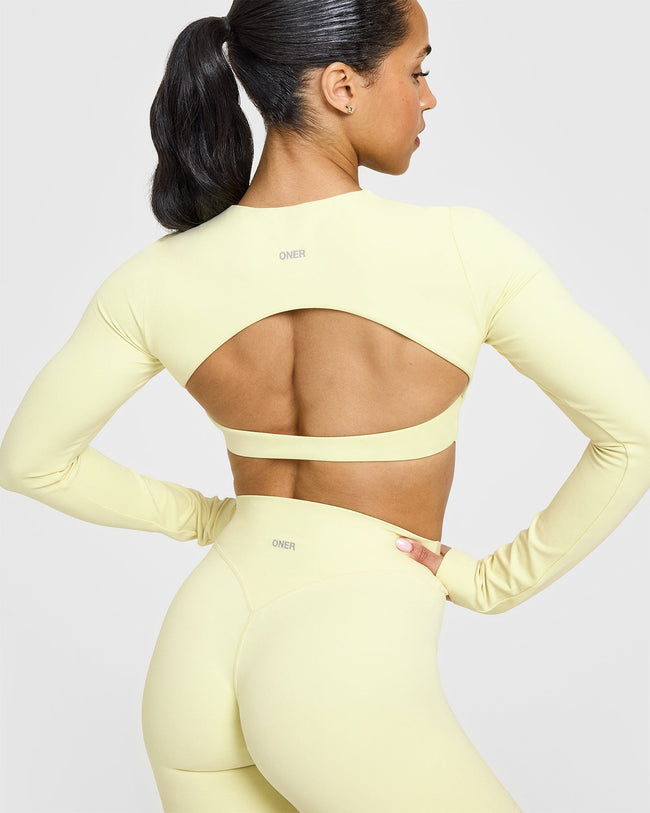 SoftMotionâ„¢ Long Sleeve Crop Top with White Logo | Pastel Yellow