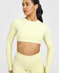 SoftMotionâ„¢ Long Sleeve Crop Top with White Logo | Pastel Yellow