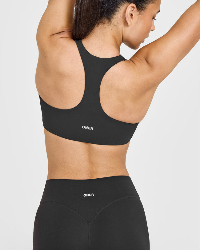 SoftMotionâ„¢ Sports Bra with White Logo | Soft Black