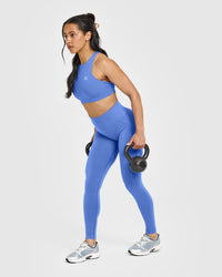 EasyLiftâ„¢ High Neck Sports Bra with White Logo | Glaucous Blue