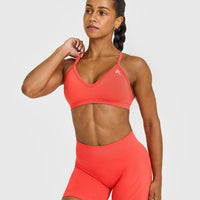 EnhanceLiftâ„¢ Seamless Strappy Sports Bra with White Logo | Charged Coral