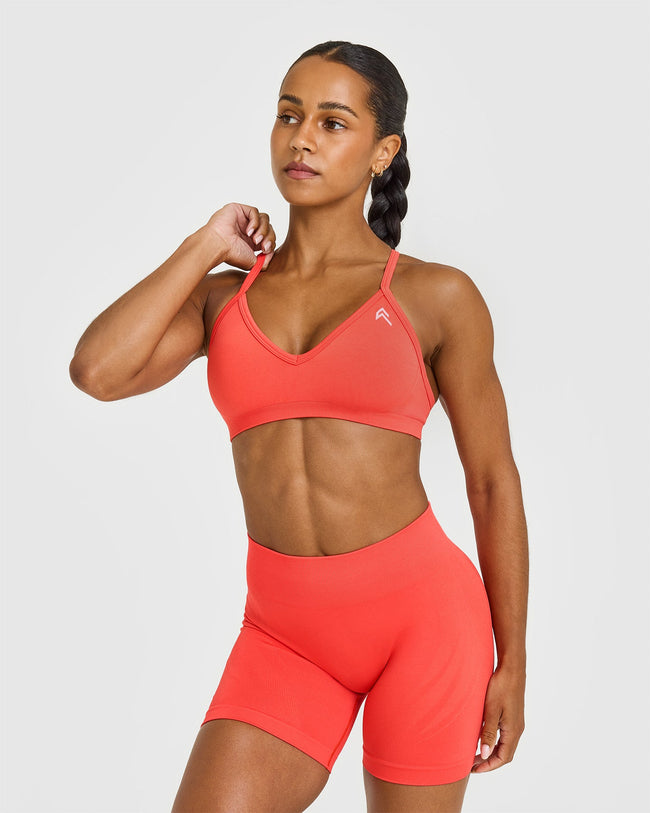 EnhanceLiftâ„¢ Seamless Strappy Sports Bra with White Logo | Charged Coral