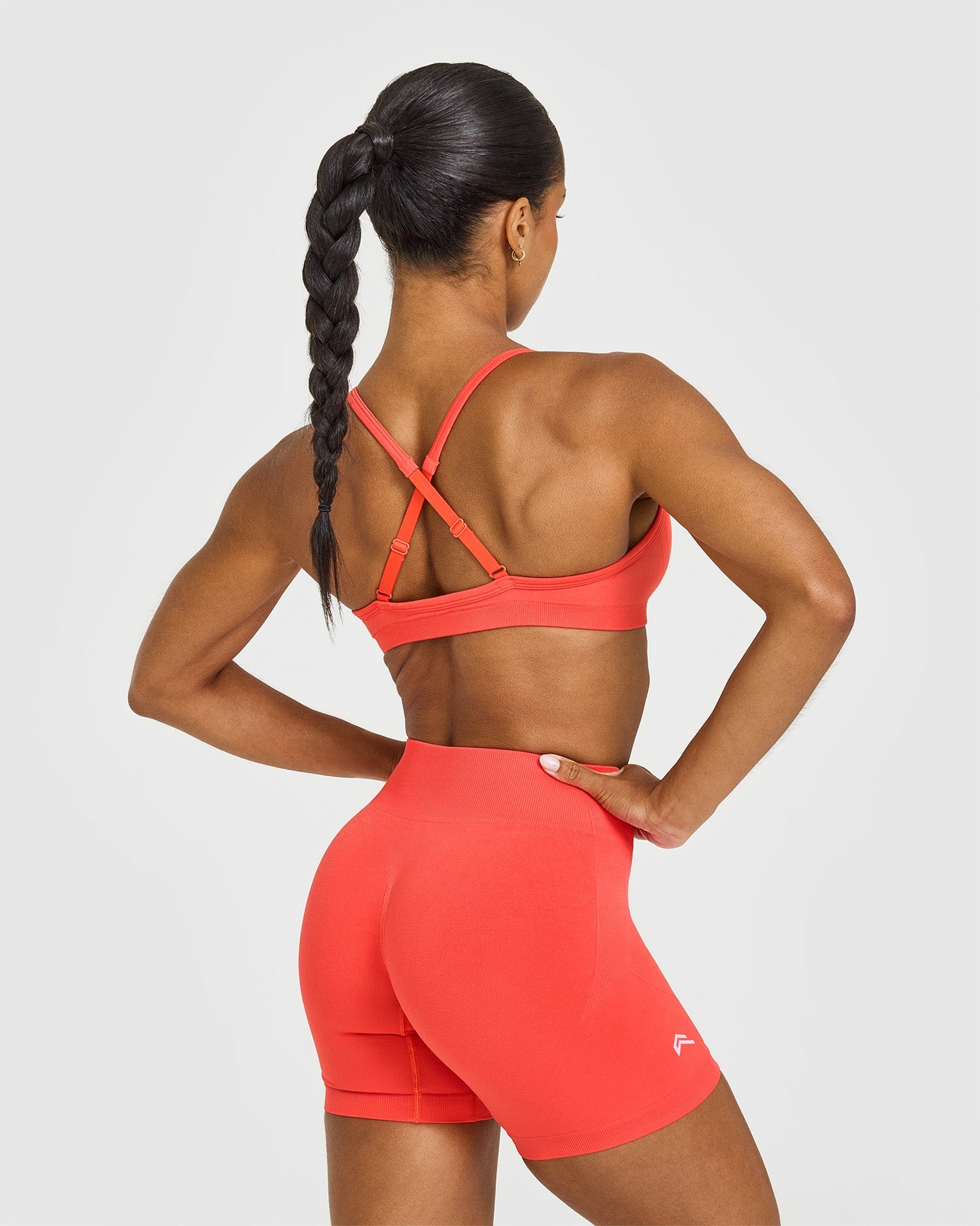 EnhanceLiftâ„¢ Seamless Strappy Sports Bra with White Logo | Charged Coral