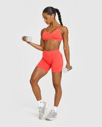 EnhanceLiftâ„¢ Seamless Strappy Sports Bra with White Logo | Charged Coral
