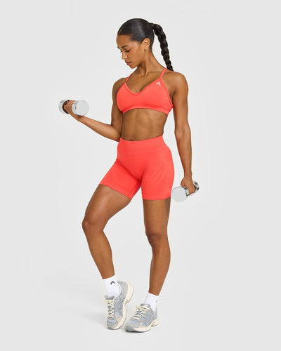 EnhanceLiftâ„¢ Seamless Strappy Sports Bra with White Logo | Charged Coral