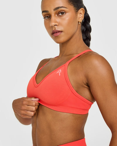 EnhanceLiftâ„¢ Seamless Strappy Sports Bra with White Logo | Charged Coral