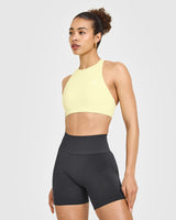 EasyLift™ High Neck Sports Bra with White Logo | Pastel Yellow