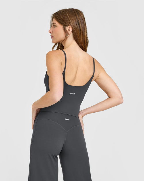 SoftMotion™ Strappy Mid Vest with Built in Bra Shelf with White Logo | Coal