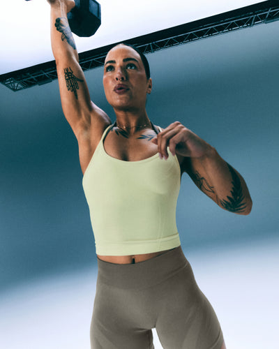 EnhanceLift™ Seamless Strappy Racer Vest with Built in Bra Shelf with Grey Logo | Pastel Yellow
