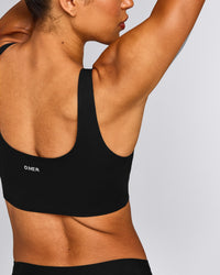 SoftMotion™ Longline Sports Bra with Grey Logo | Black