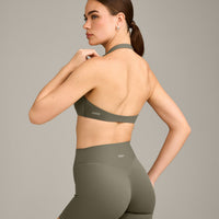 SoftMotion™ Minimal Halter Neck Bralette with Grey Logo | Alpine Green