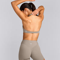 SoftMotion™ Minimal Halter Neck Bralette with White Logo | Warm Sand