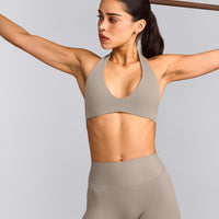 SoftMotion™ Minimal Halter Neck Bralette with White Logo | Warm Sand