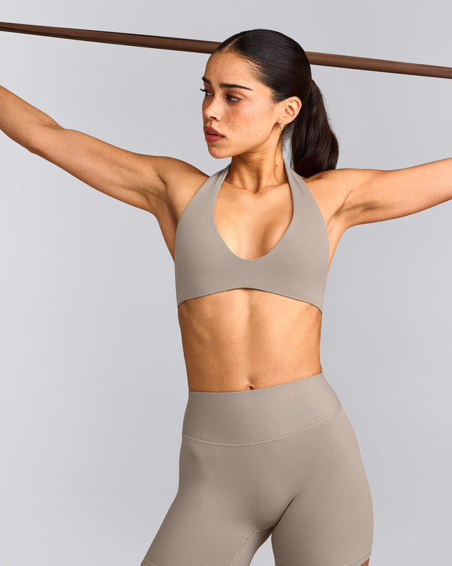 SoftMotion™ Minimal Halter Neck Bralette with White Logo | Warm Sand
