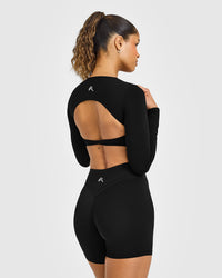 Unified Twist Front Long Sleeve Crop Top White Logo | Black