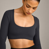 SoftMotion™ Scoop Neck Long Sleeve Crop Top with Built in Bra Shelf with Grey Logo | Coal