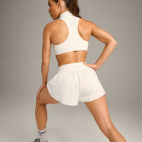 EasyLift™ Zip High Neck Sports Bra with Grey Logo | Marshmallow White