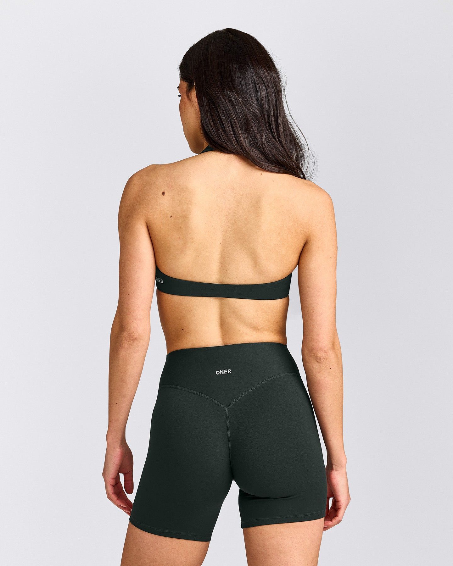 SoftMotion™ Minimal Halter Neck Bralette with Grey Logo | Emerald Noir