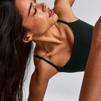 SoftMotion™ Strappy Sports Bra with Grey Logo | Emerald Noir