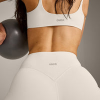 SoftMotion™ Strappy Sports Bra with Grey Logo | Marshmallow White