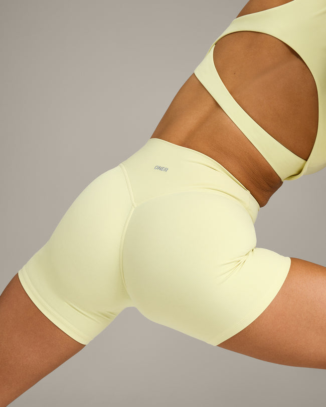 SoftMotion™ High Waisted Shorts 6" with Grey Logo | Pastel Yellow