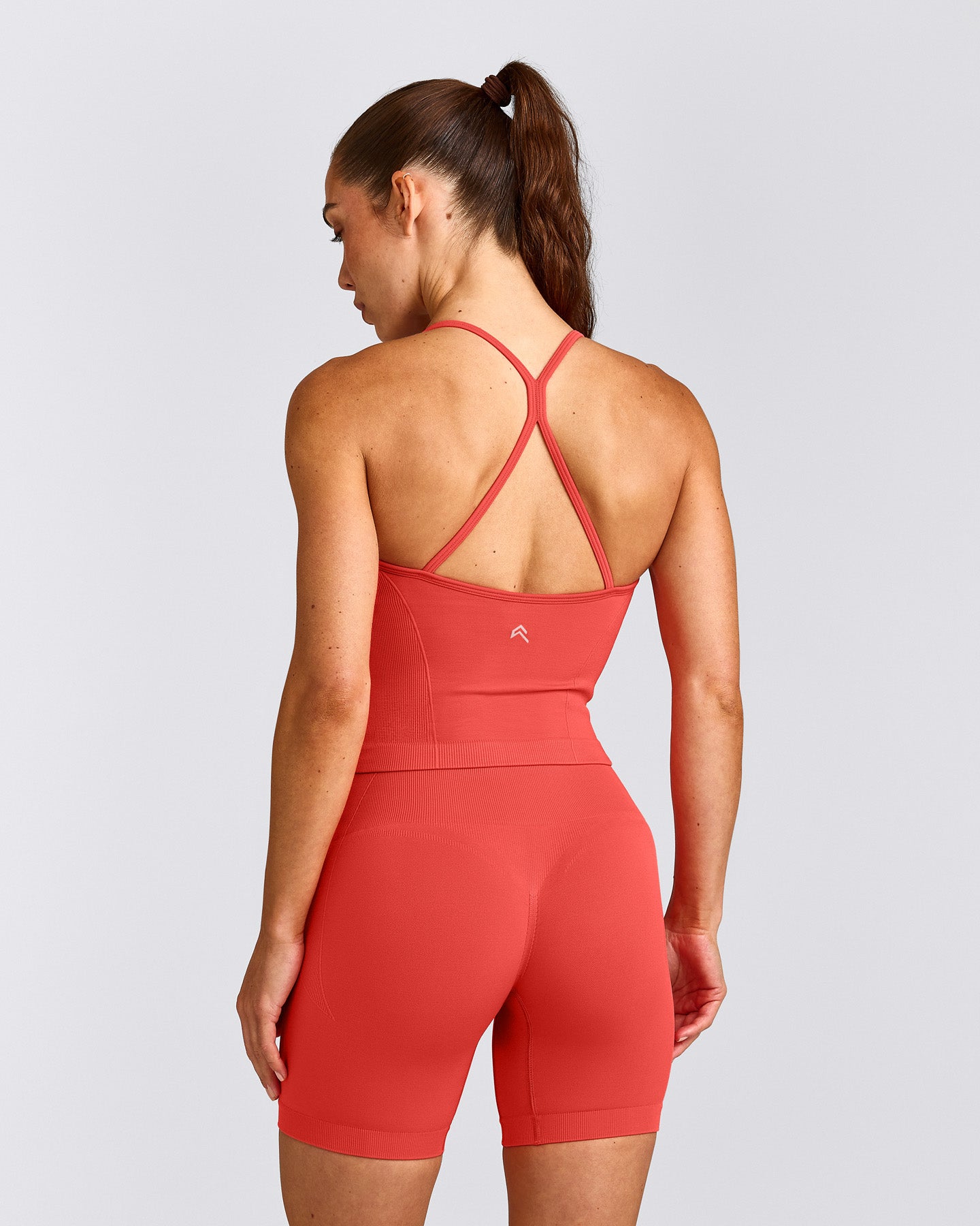 EnhanceLift™ Seamless Strappy Racer Vest with Built in Bra Shelf with Grey Logo | Dark Charged Coral