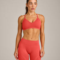 EnhanceLift™ Seamless Strappy Sports Bra with Grey Logo | Dark Charged Coral