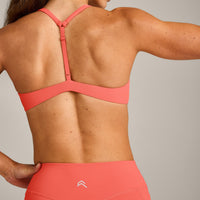UnifiedMove™ T Back Minimal Bralette with Reflective Logo | Light Charged Coral