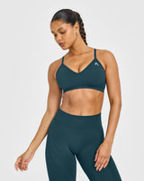 EnhanceLift™ Seamless Strappy Sports Bra with White Logo | Washed Oil Blue